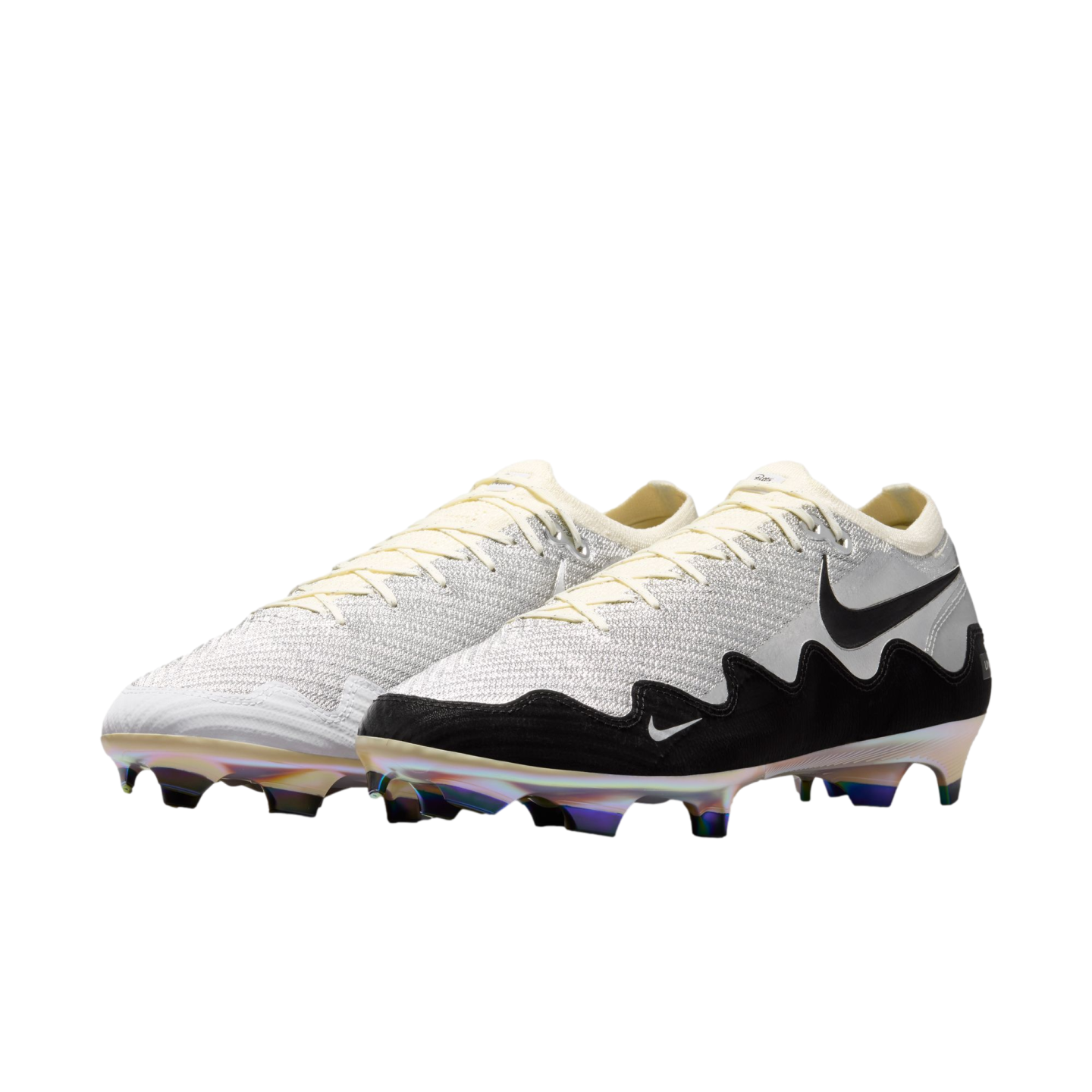 A pair of Nike soccer cleats featuring a white textured upper, black wavy lower section, and iridescent soleplate on a black background.