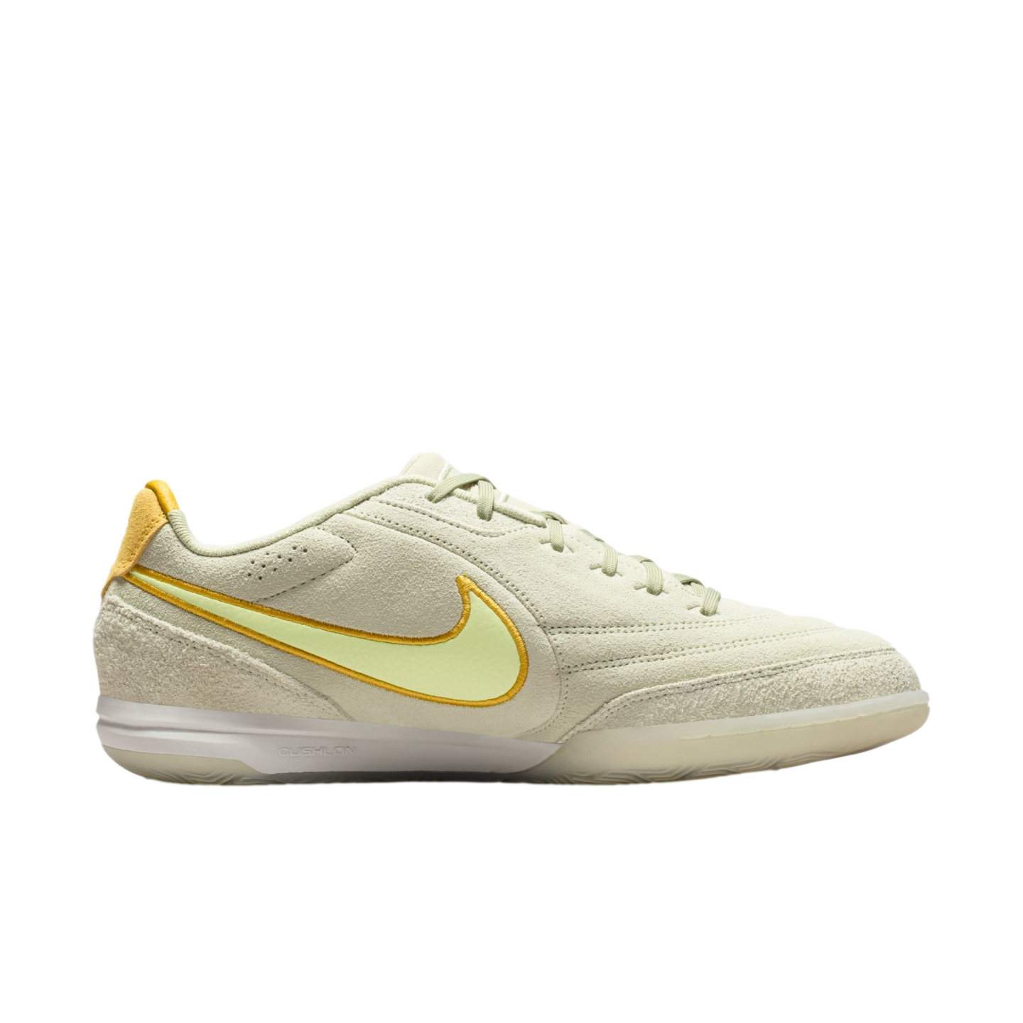 Side view of a Nike Streetgato indoor soccer shoe with a pale green suede upper, yellow Swoosh, and white Cushlon midsole against a black background.