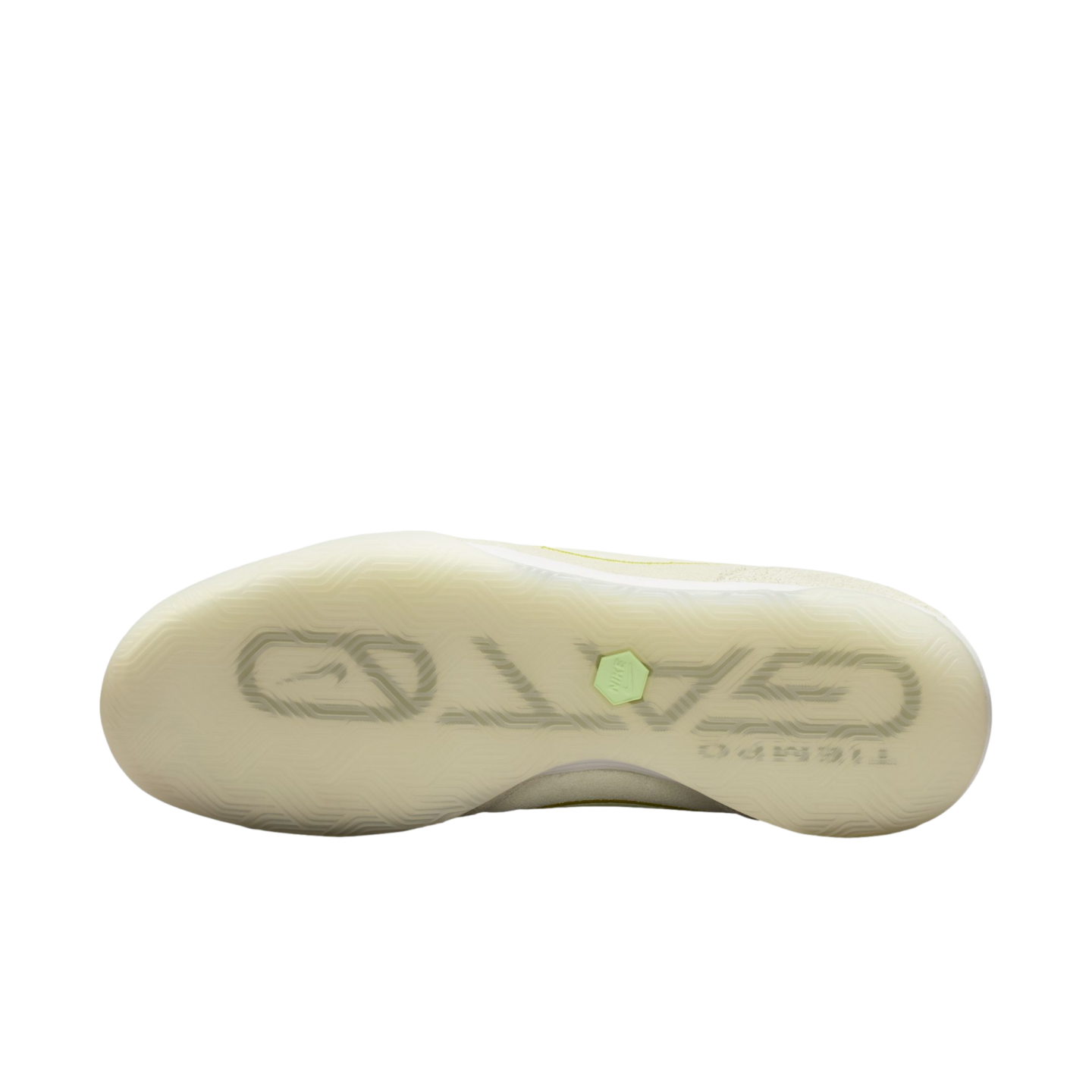 The translucent off-white sole of a Nike Tiempo Gato soccer shoe, featuring a stylized "GATO" logo and a small lime green hexagonal icon, centered against a solid black background.