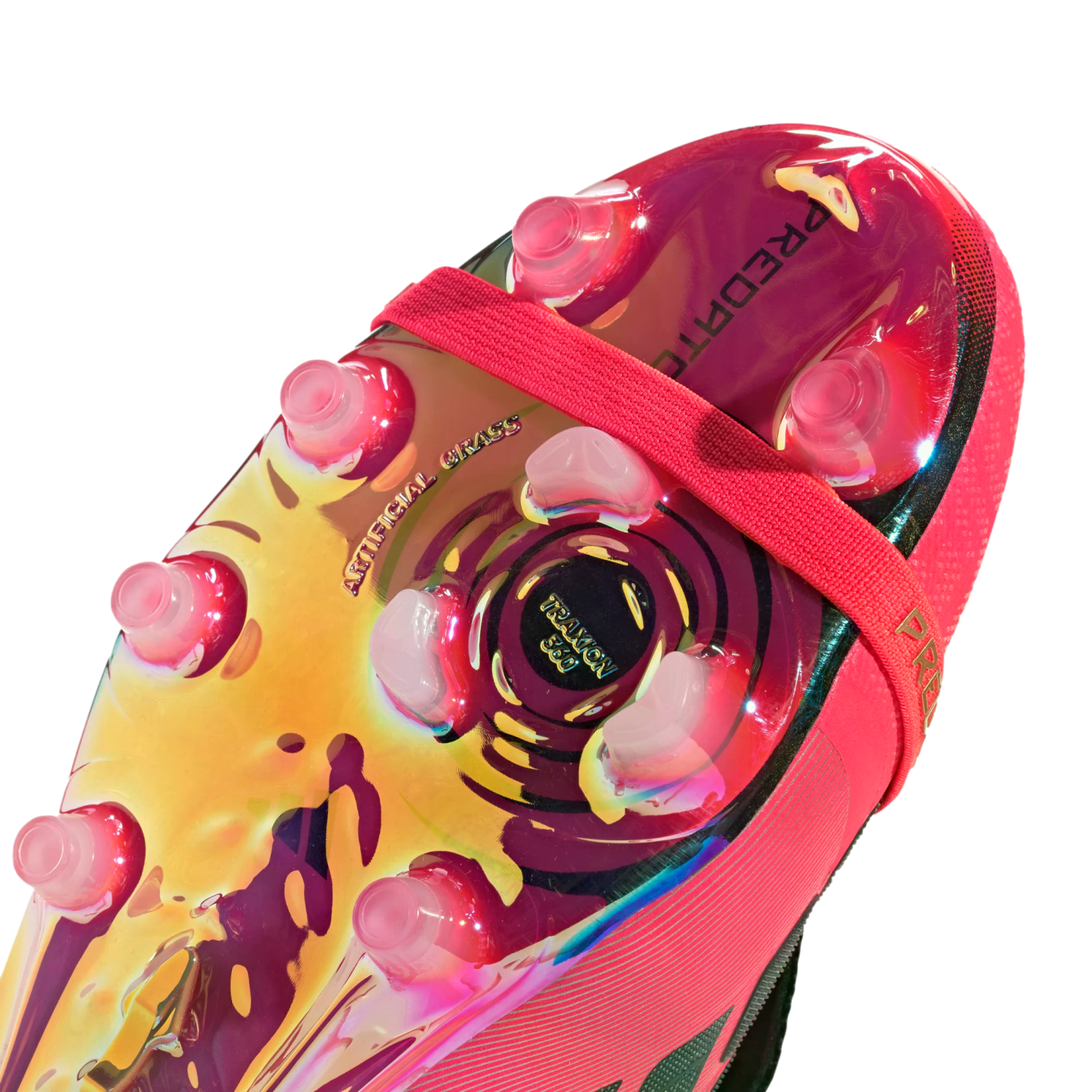 Iridescent gold and pink soleplate of a soccer cleat for artificial grass, featuring clear studs and a pink elastic midfoot strap.