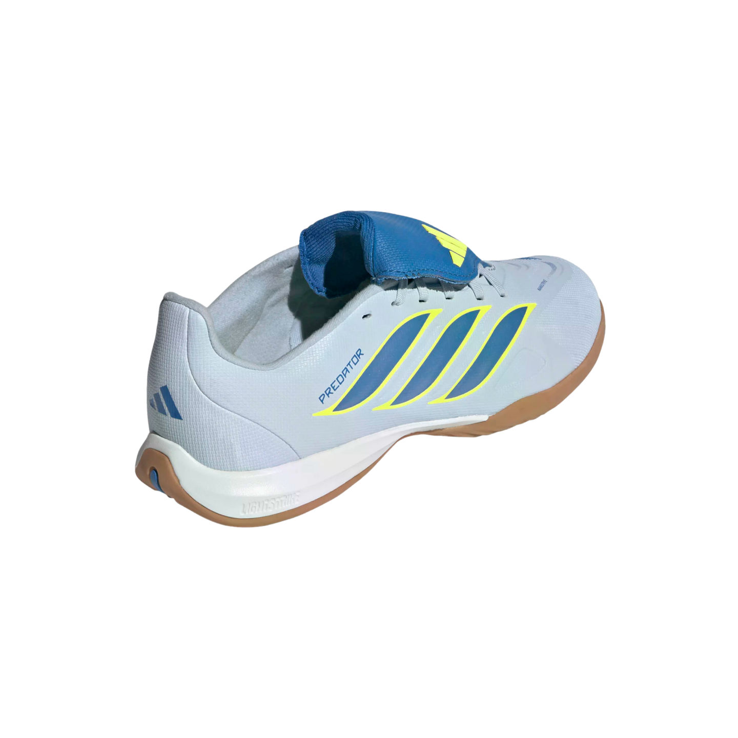 A rear three-quarter view of a light blue Adidas Predator indoor soccer shoe against a black background. The shoe features three diagonal dark blue stripes outlined in yellow on the side and the word "PREDATOR" in blue. It has a prominent blue fold-over tongue with a yellow Adidas logo, a white midsole with "LIGHTSTRIKE" branding, and a gum rubber outsole.