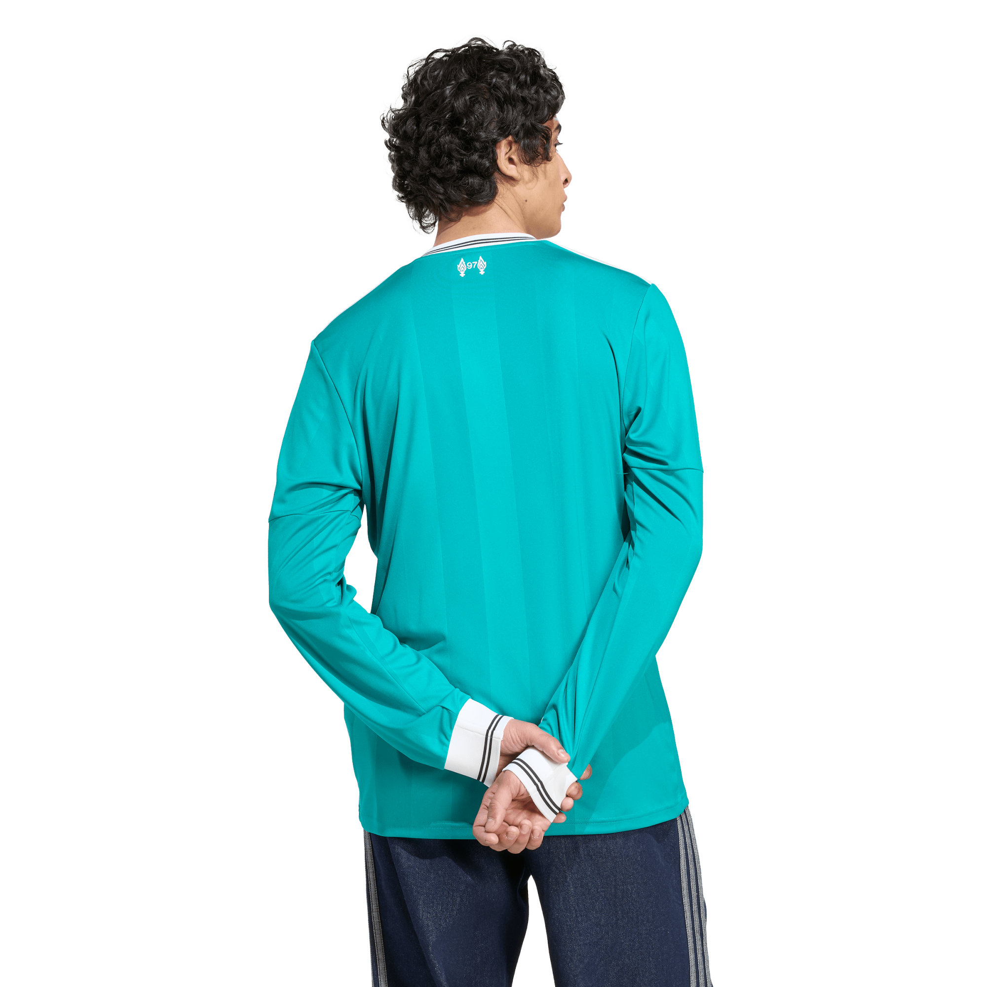 Back view of a person in a long-sleeved teal athletic jersey with white striped trim, standing with hands behind their back on a white background.