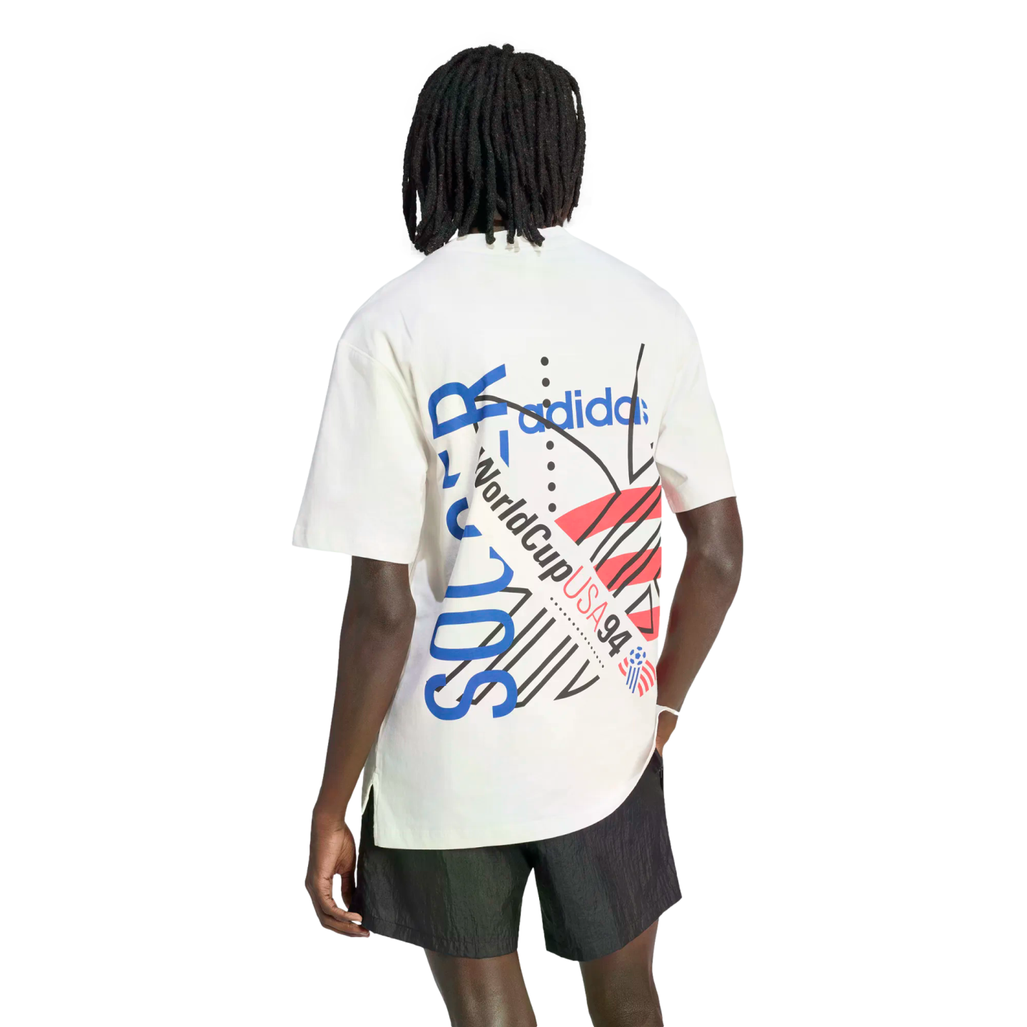 Rear view of a person with dreadlocks wearing a white t-shirt with a large World Cup USA 94 graphic and black shorts.