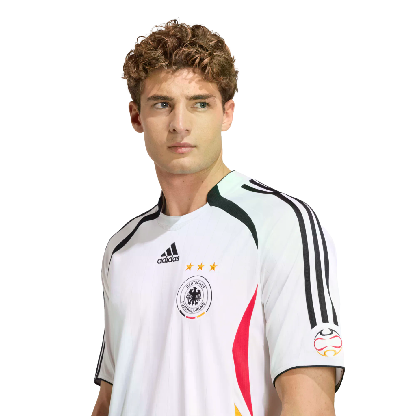 A man with curly hair wearing a white Adidas Germany national football team jersey, looking off to the side against a white background.