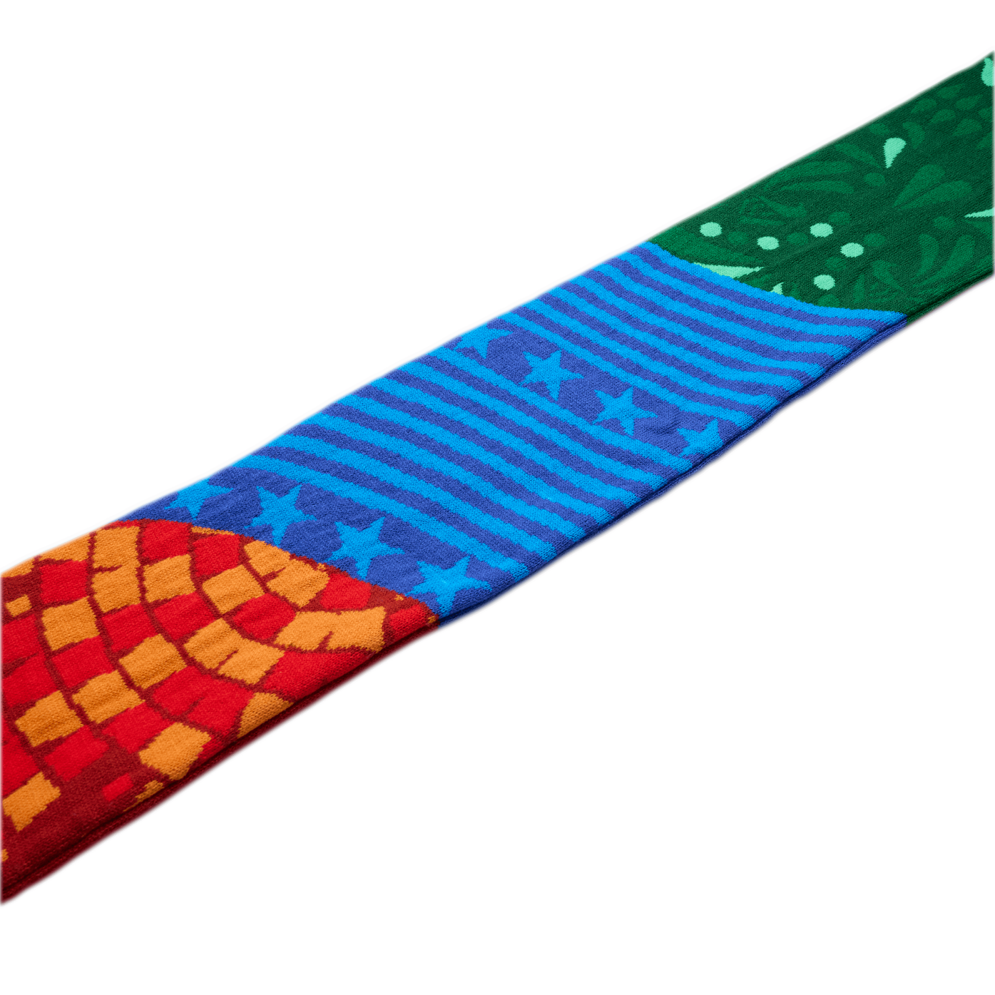 A colorful patterned fabric strip featuring a red and orange mosaic, blue stars and stripes, and a green floral design, set against a white background.