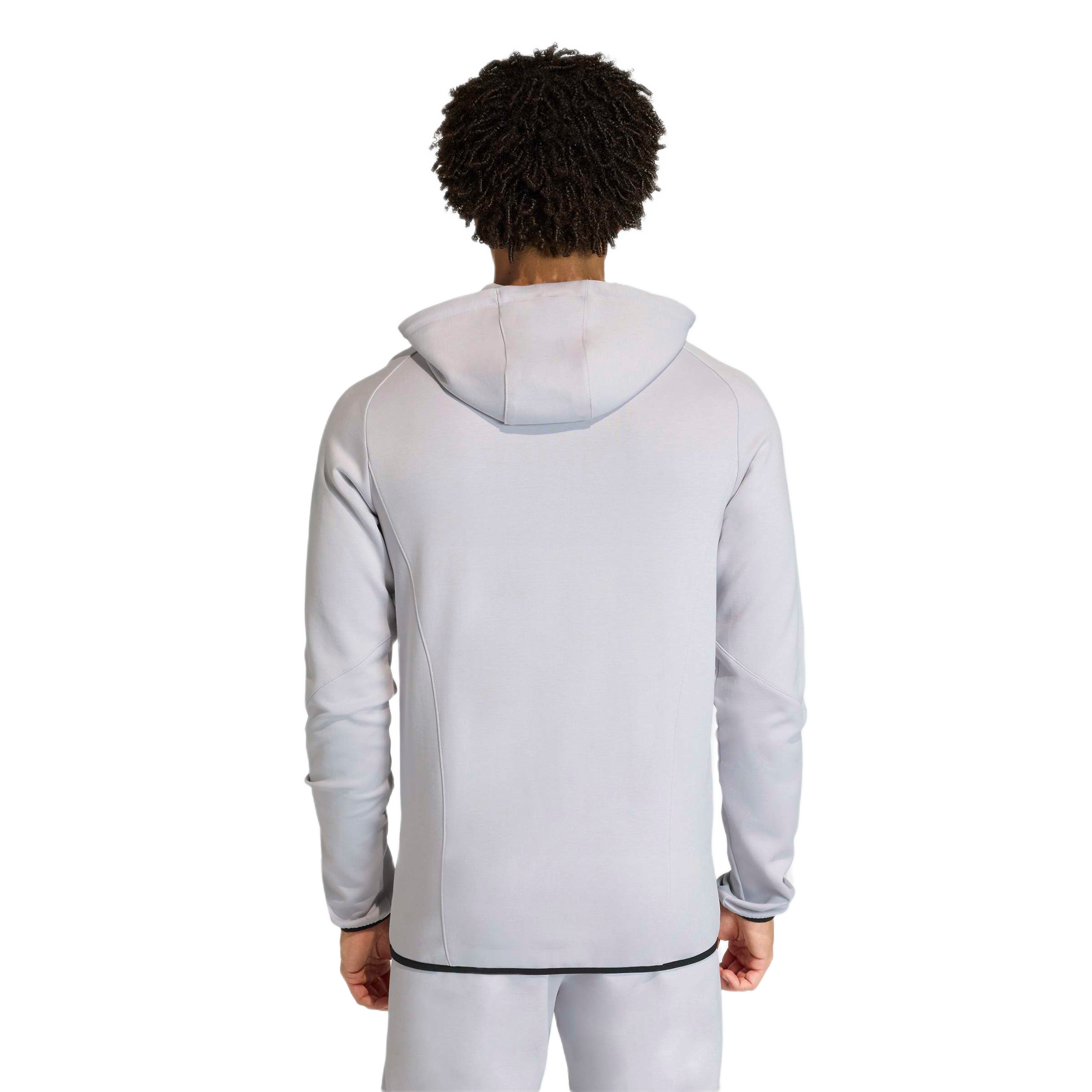 Back view of a person with dark curly hair wearing a light-grey hooded track suit. The hoodie features a thin black trim along the bottom edge.