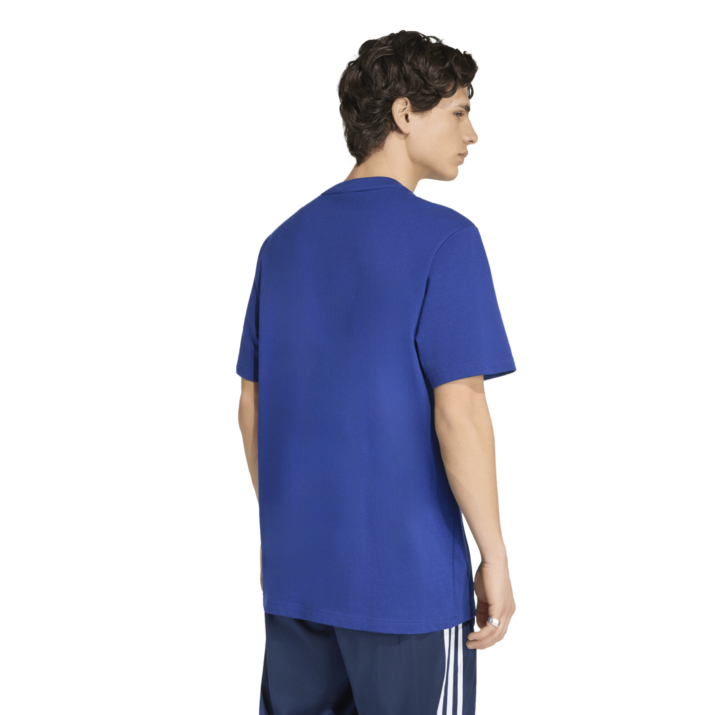 Back view of a man wearing a royal blue crewneck t-shirt and navy blue athletic shorts with white side stripes, against a white background.
