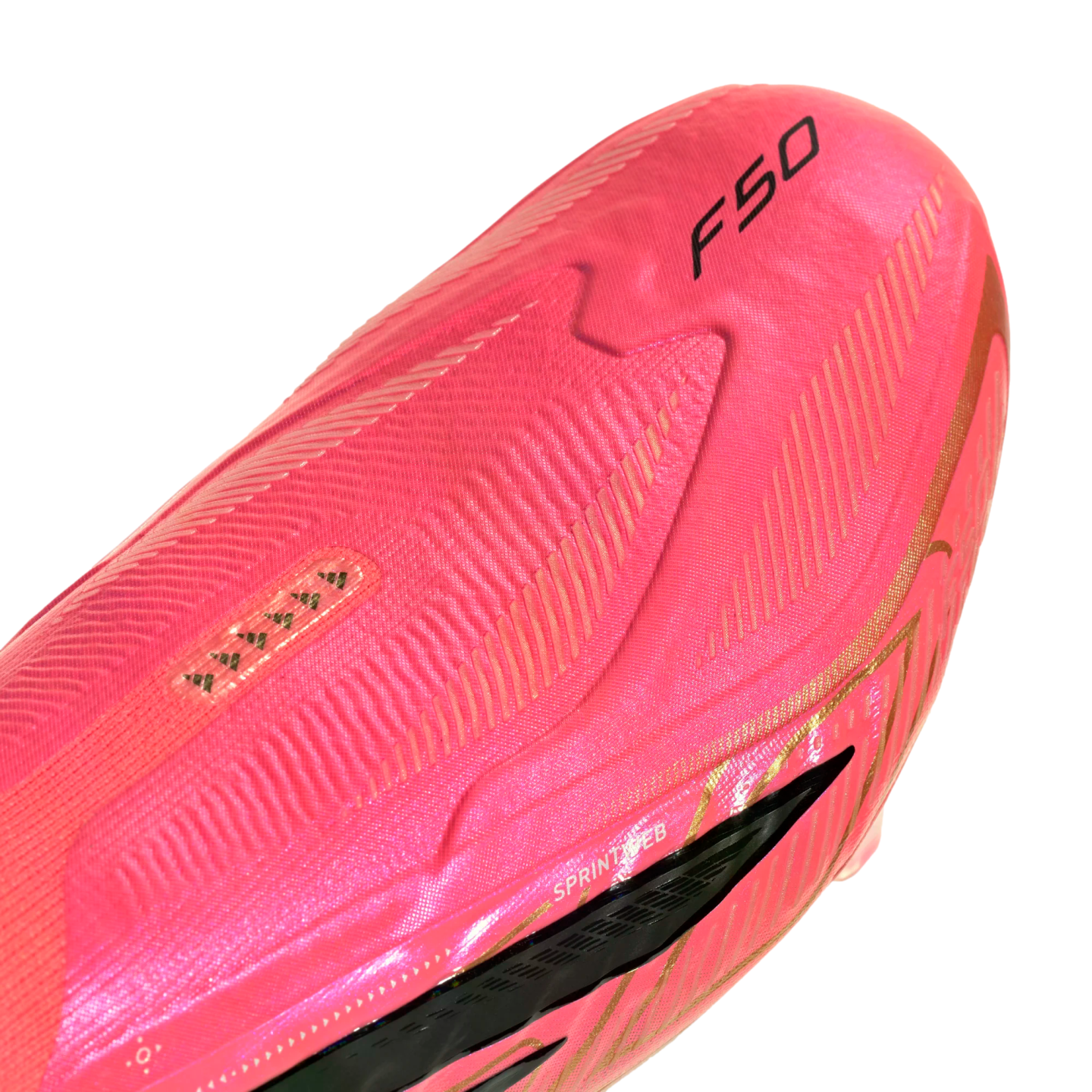 Close-up of a vibrant pink soccer cleat with gold details, featuring the "F50" logo and "SPRINTWEB" text on a textured upper.