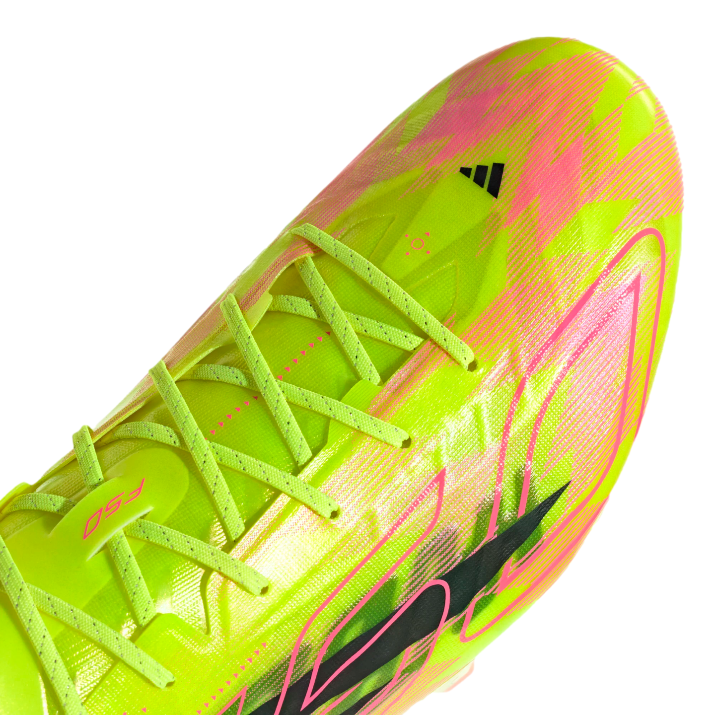 Close-up of a neon yellow and pink Adidas F50 football boot with crossed lime laces, set against a black background. Bold graphic patterns decorate the upper.