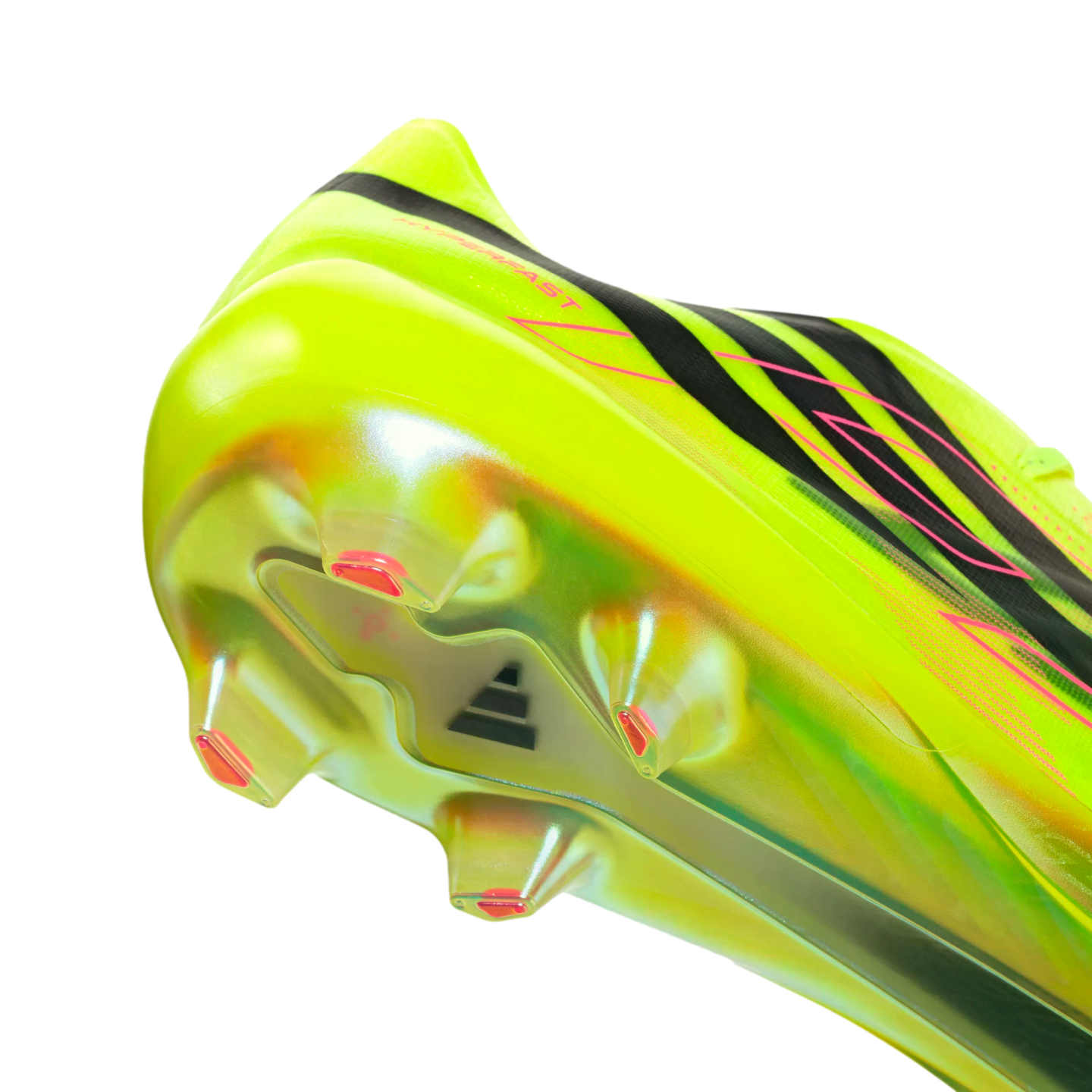 Close-up of a neon yellow Adidas soccer cleat's heel and iridescent soleplate. Features black stripes, pink accents, and translucent studs against a solid black background.