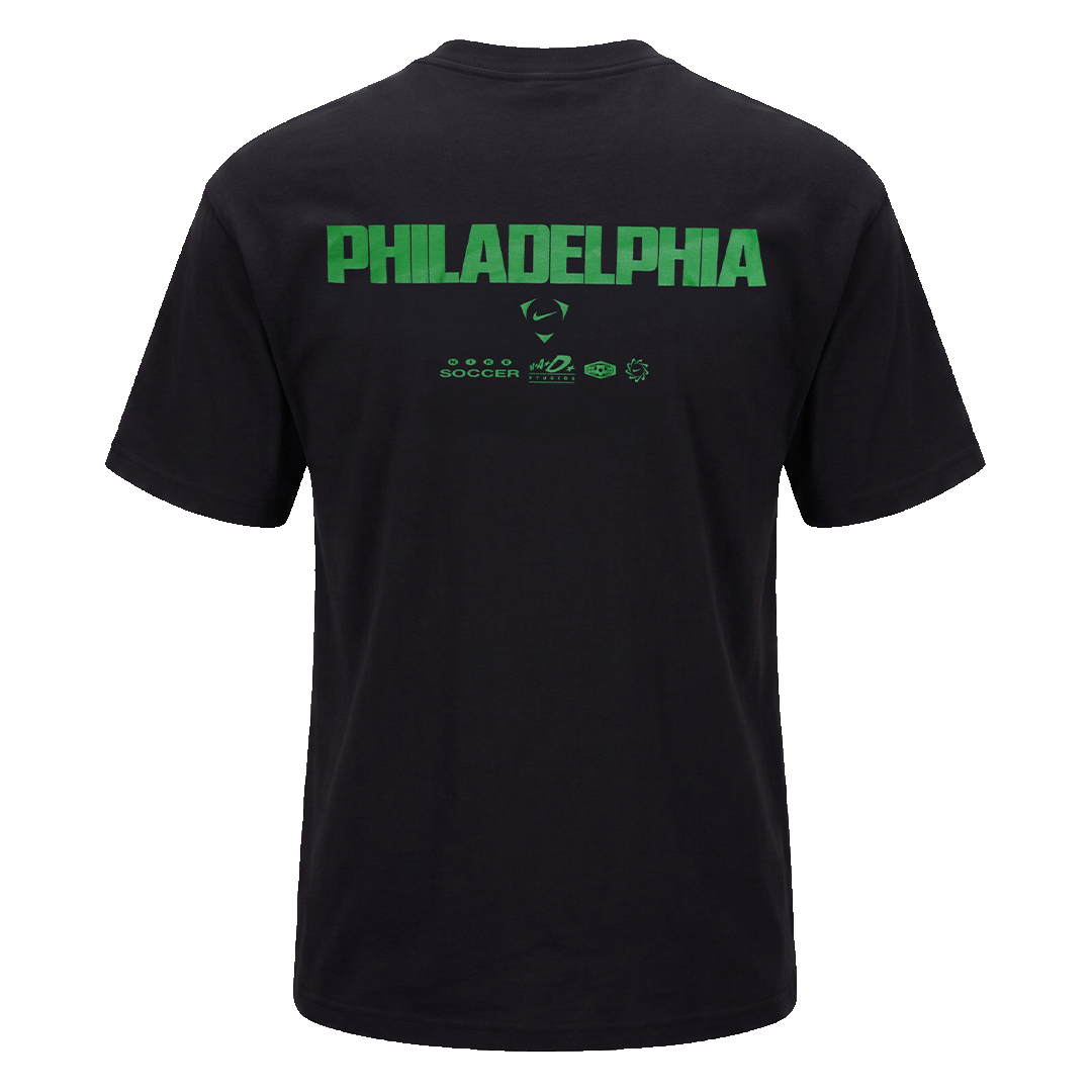 Back of a black t-shirt featuring "PHILADELPHIA" in large green block lettering above several smaller green Nike Soccer logos.