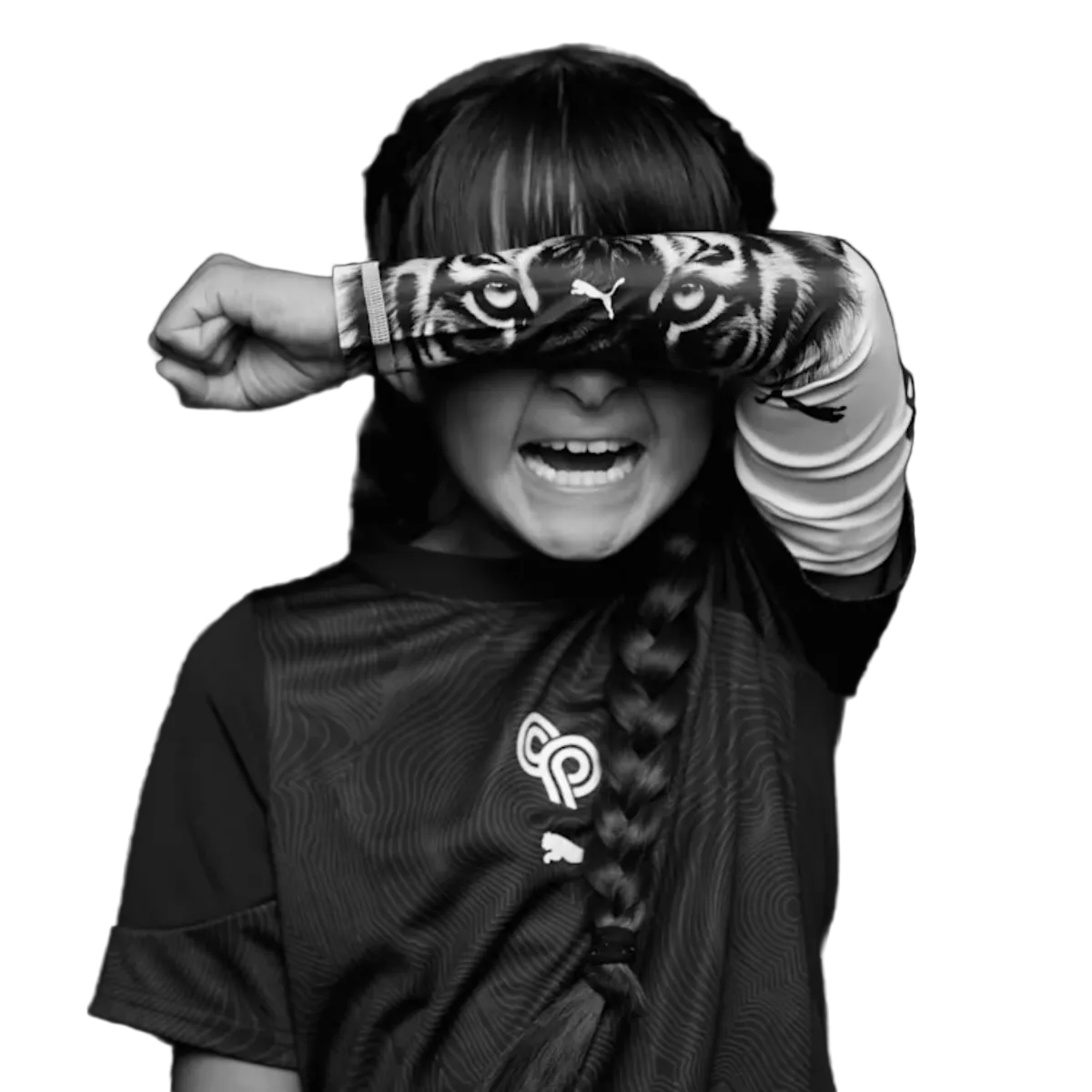 Black and white photo of a smiling child with their arm over their face. A tiger eye graphic on their sleeve aligns with their eyes, creating a mask effect.