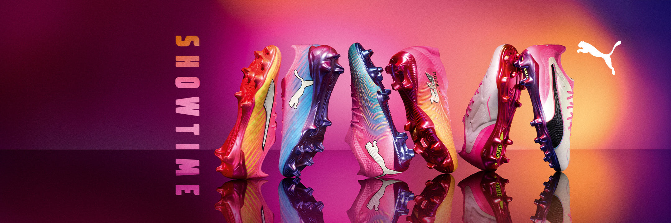 Vibrant Puma soccer cleats lined up on a reflective surface against a pink-orange gradient background with vertical "SHOWTIME" text on the left.