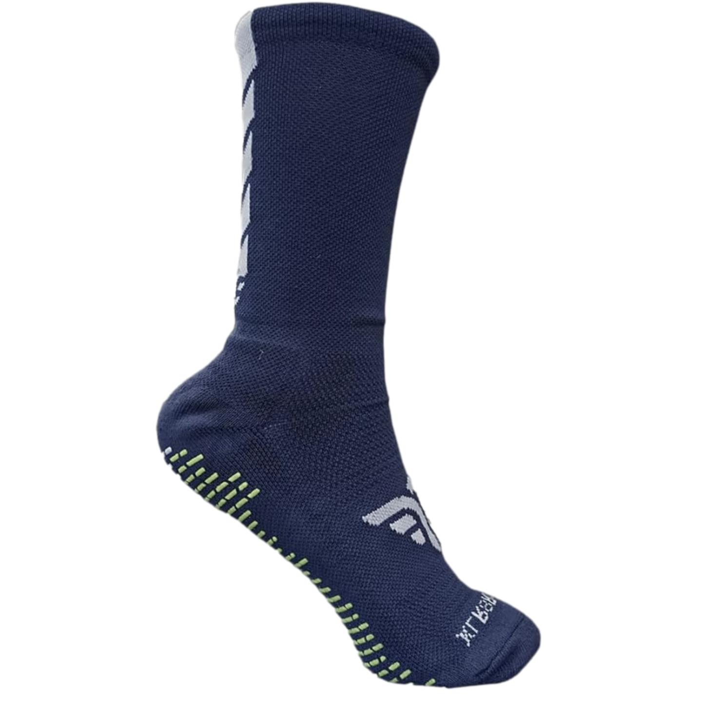 A navy blue crew-length athletic sock with white geometric accents and lime green non-slip grip pads on the sole, set against a black background.