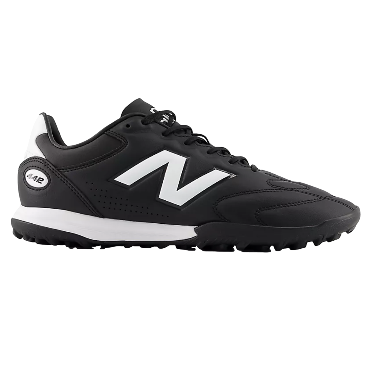 A black New Balance 442 turf soccer shoe featuring a large white 'N' logo and white midsole detail, shown from a side profile against a black background.
