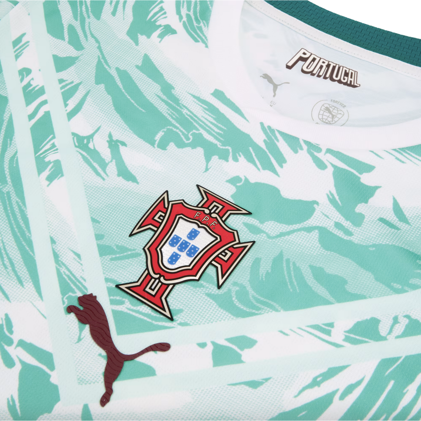 A close-up of the chest area of a Portugal national football team jersey, featuring a white and mint green abstract marbled pattern. The team crest is centered, with a dark maroon textured Puma logo on the lower left and stylized "PORTUGAL" text inside the collar.