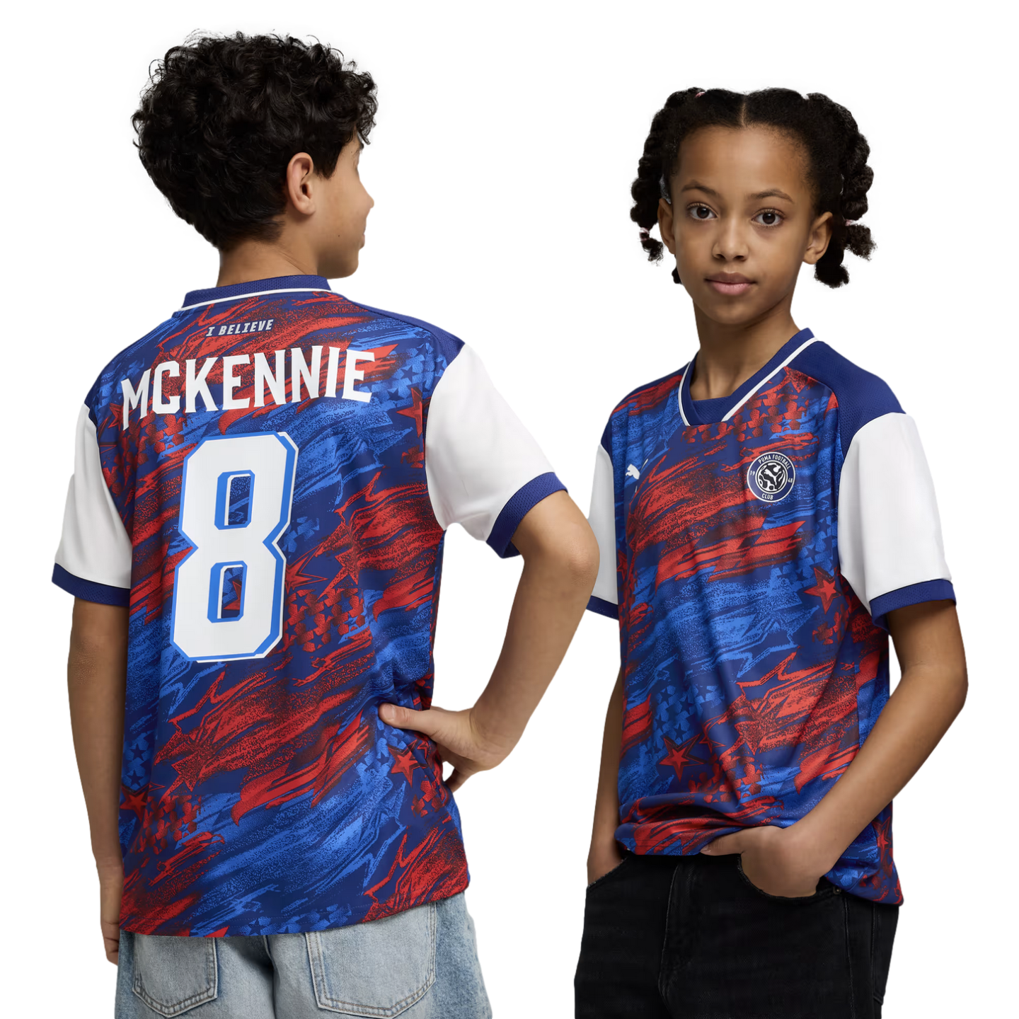 A boy and a girl model a red, blue, and white abstract-patterned soccer jersey against a black background. The boy on the left shows the back of the shirt, which features the name "MCKENNIE" and the number "8" in white. The girl on the right shows the front of the jersey, which has a circular team crest on the chest.