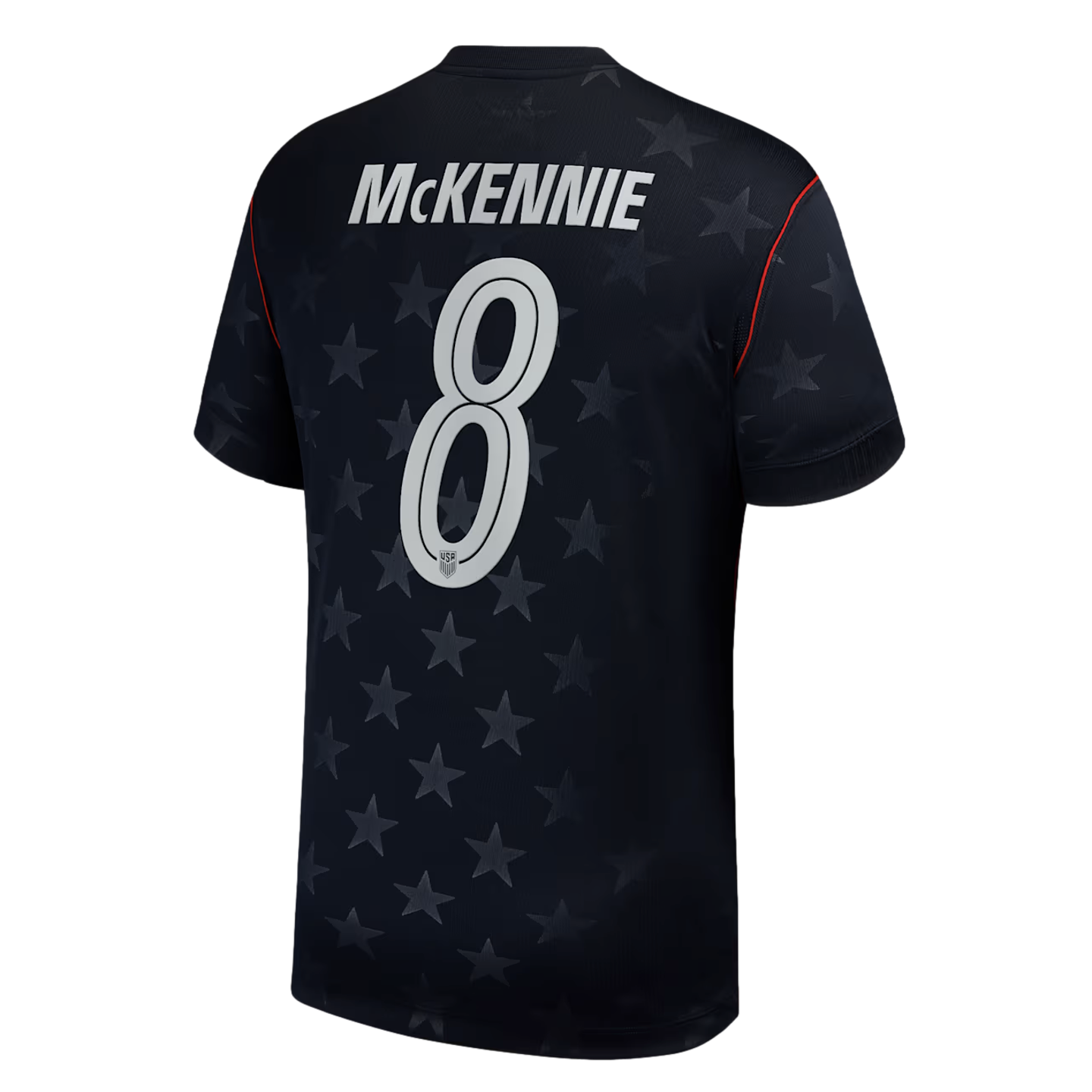 Back of a navy blue soccer jersey with "MCKENNIE" and the number "8" in white. The jersey features a tonal star pattern and thin red piping on the shoulders.