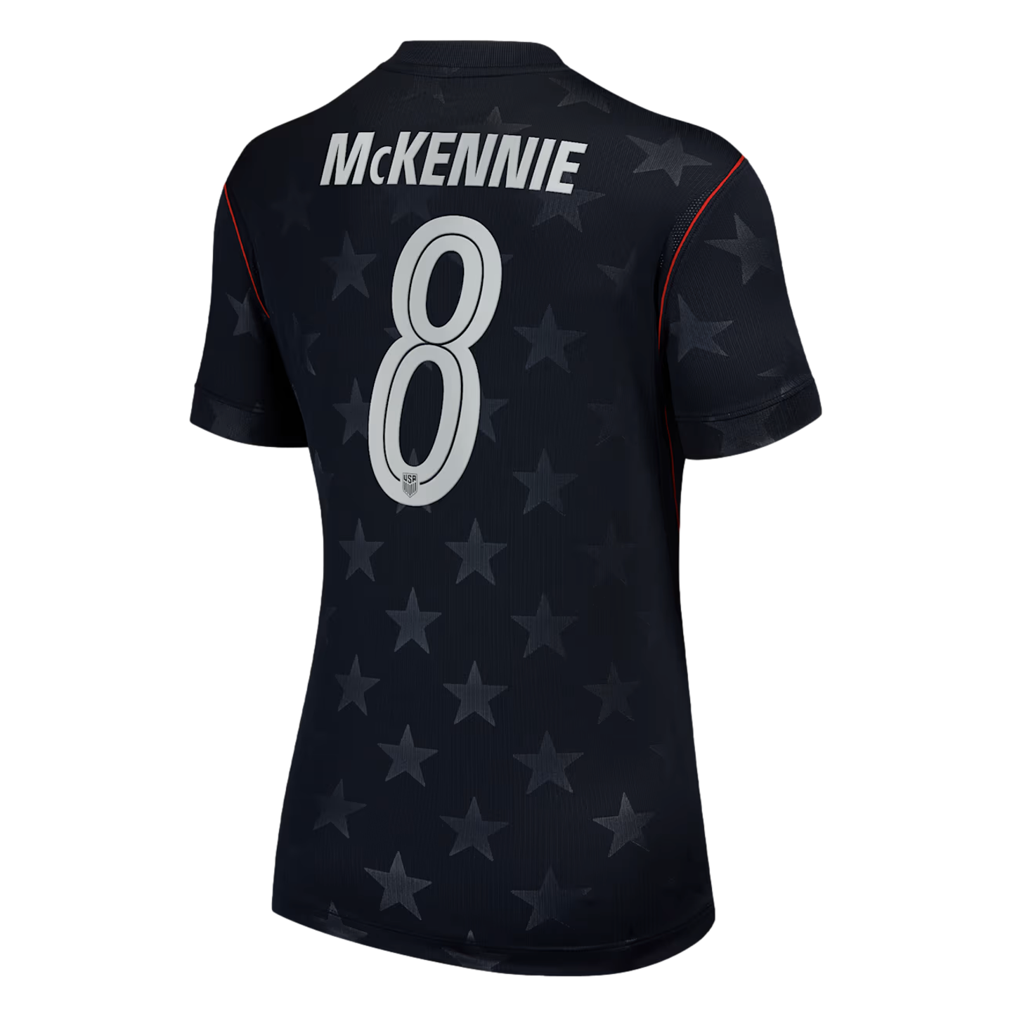 The back of a dark blue USA soccer jersey with white text "MCKENNIE" and number 8 over a subtle star pattern. Red trim on shoulders.