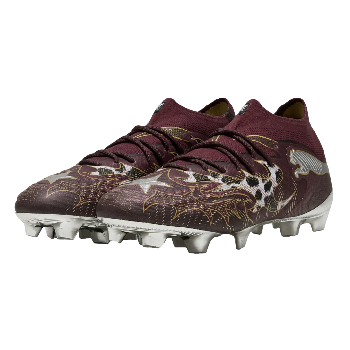 Burgundy Puma soccer cleats featuring an intricate gold and silver graphic design and a metallic silver soleplate, displayed against a solid black background.