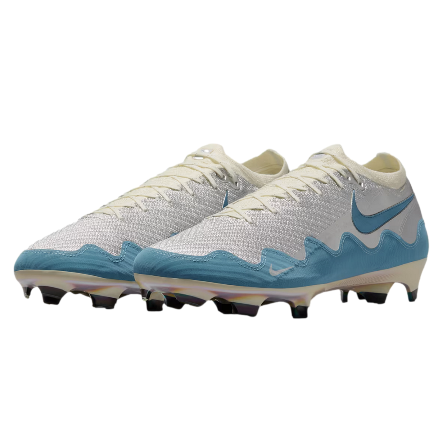 A pair of Nike soccer cleats with a textured silver-white upper, wavy light blue trim along the sides, and cream laces, shown against a solid black background.
