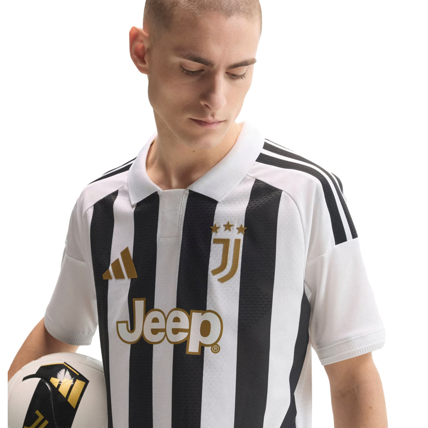 A man wearing a black and white striped Juventus soccer jersey with gold accents, holding a soccer ball against a white background.