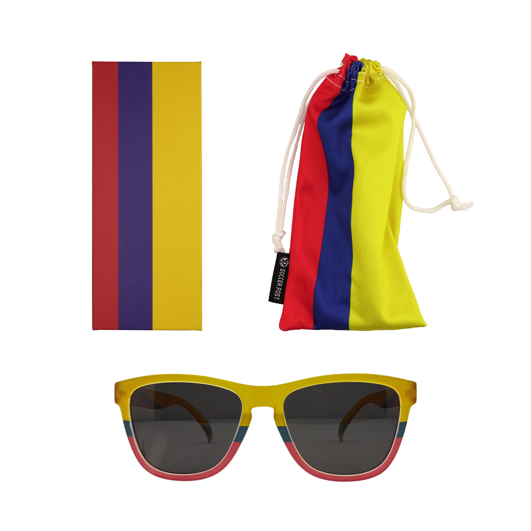 A set of sunglasses, a drawstring bag, and a box, all featuring red, blue, and yellow stripes. The bag has a "SOCCER POST" label.
